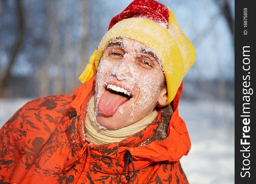 Portrait of young guy smiles against winter wood. Portrait of young guy smiles against winter wood