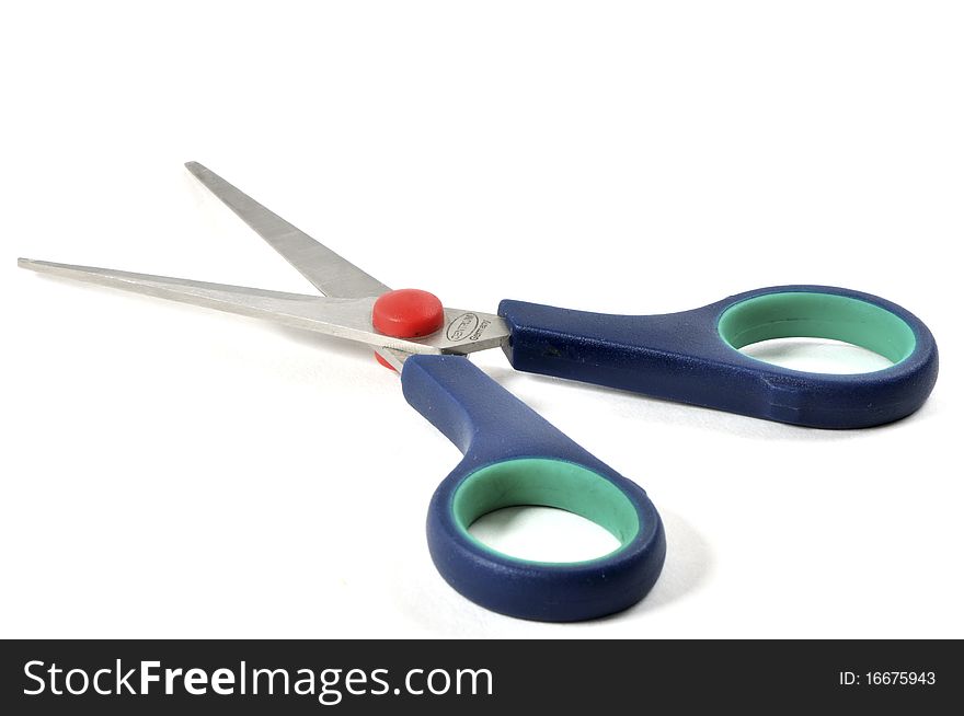 Blue red and green plastic scissors isolated over white background