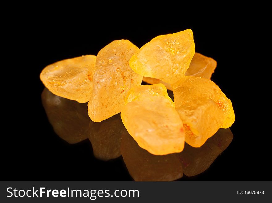 Bath salts with orange extract on a black background. Macro photography. Bath salts with orange extract on a black background. Macro photography.