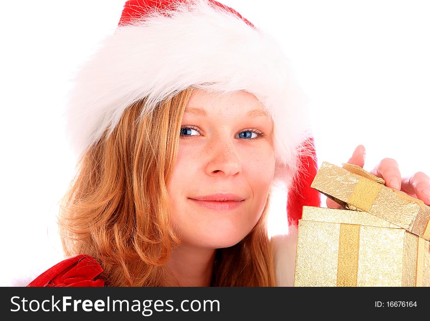 Miss santa is opening a golden gift box in her hand and smiling into the camera