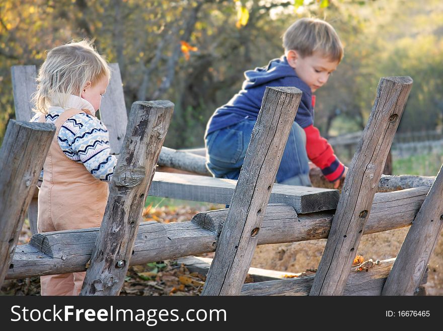 Brother and sister playing outdoors on farm