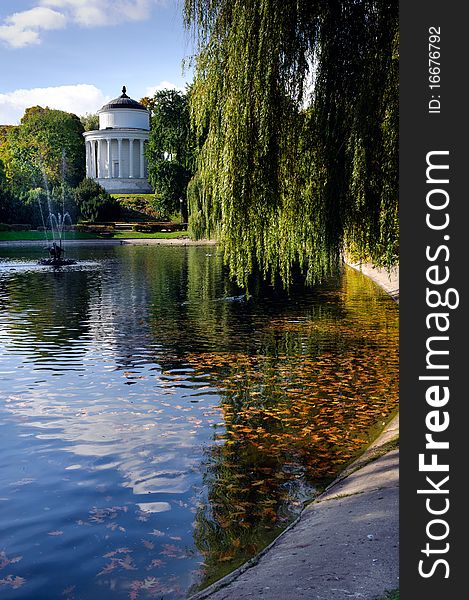 Autumn park landscape with temple and fontain