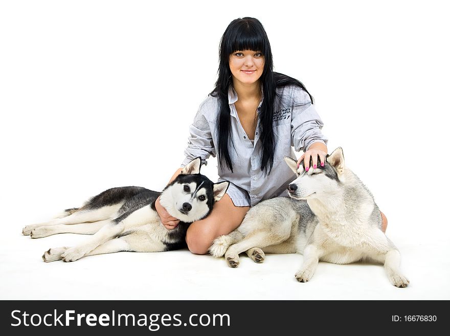 Cute girl with two siberian husky isolated on white