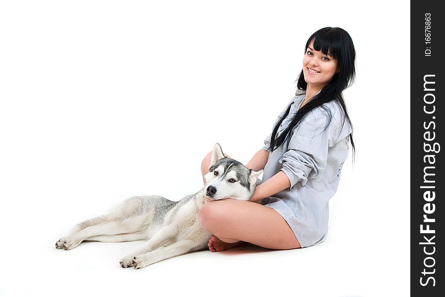 Cute girl with grey siberian husky isolated on white