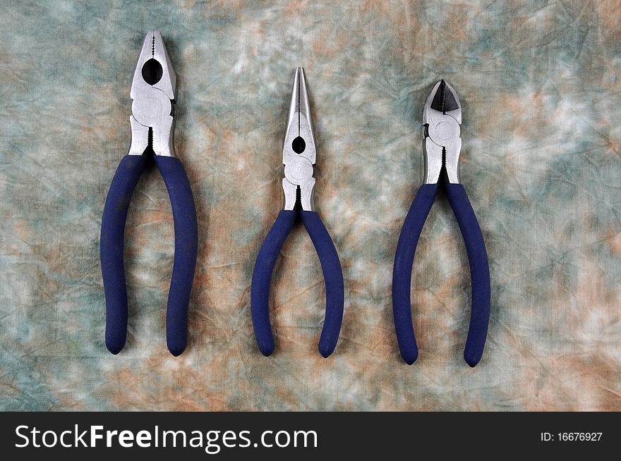 A combination pliers, long nose pliers and side cutter, photographed in a studio. A combination pliers, long nose pliers and side cutter, photographed in a studio.