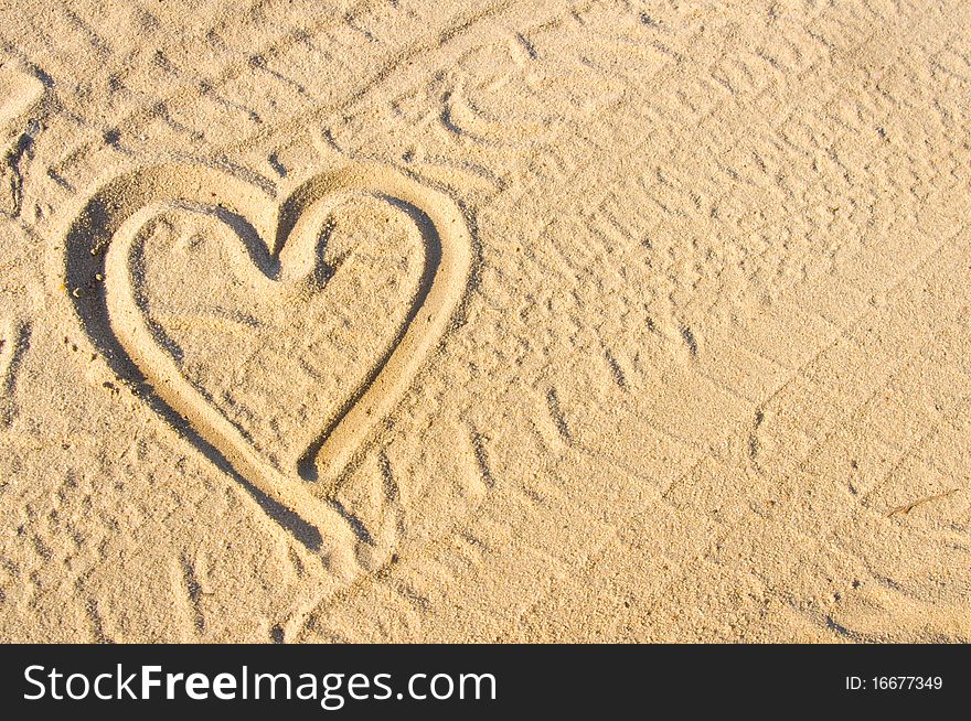 Heart sign drawn on sand