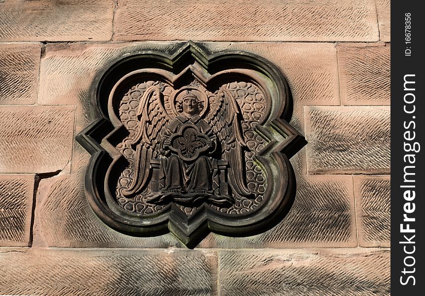 An Ornate Stone Carving On Church Wall.