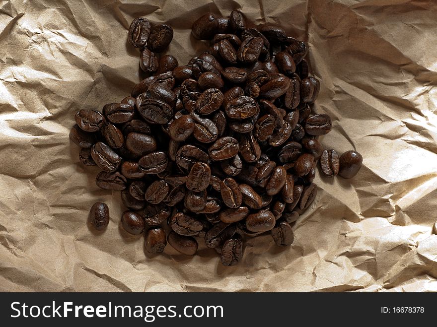Coffee beans on a piece of recycled paper