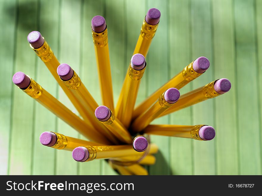 Yellow pencils tied together on a green table