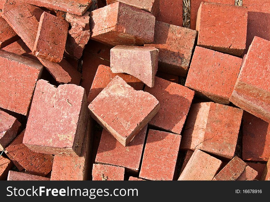 Closeup of pile of red, dirty, broken bricks. Closeup of pile of red, dirty, broken bricks