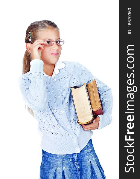 Beautiful schoolgirl in glasses with books. In the studio