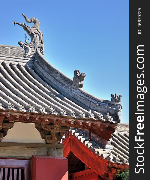 Featured elaborate roof and eave of a Chinese old temple, shown as traditional architecture and decoration style and detail. Featured elaborate roof and eave of a Chinese old temple, shown as traditional architecture and decoration style and detail.