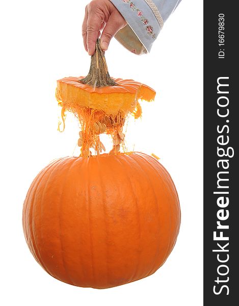 Orange pumpkin isolated on a white background with its top floating above it in mid air. Orange pumpkin isolated on a white background with its top floating above it in mid air.