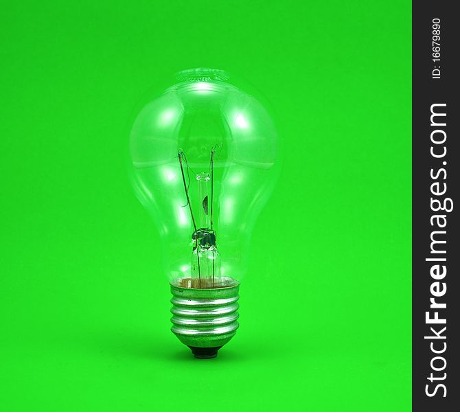 Compact light bulb isolated on green background. Compact light bulb isolated on green background