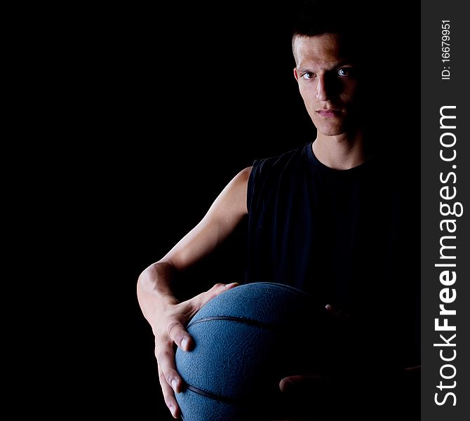 Young teenage basketball player in a studio setting with hip athletic clothing. Young teenage basketball player in a studio setting with hip athletic clothing.