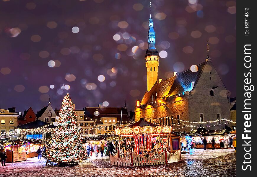 Christmas in the city  holiday New year  evening light  and snowflakes fall  in Tallinn old town squar town hall square, best mark