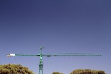 Lifting Crane & Trees On Sky Background Royalty Free Stock Images
