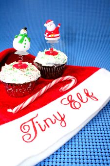 Santa Hat With Two Decorated Cupcakes Stock Photos Santa Hat With Two Decorated Cupcakes Stock Photos