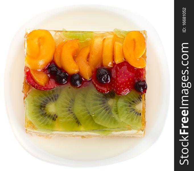 Close-up curd cake with jellied fruits and berries, isolated on white