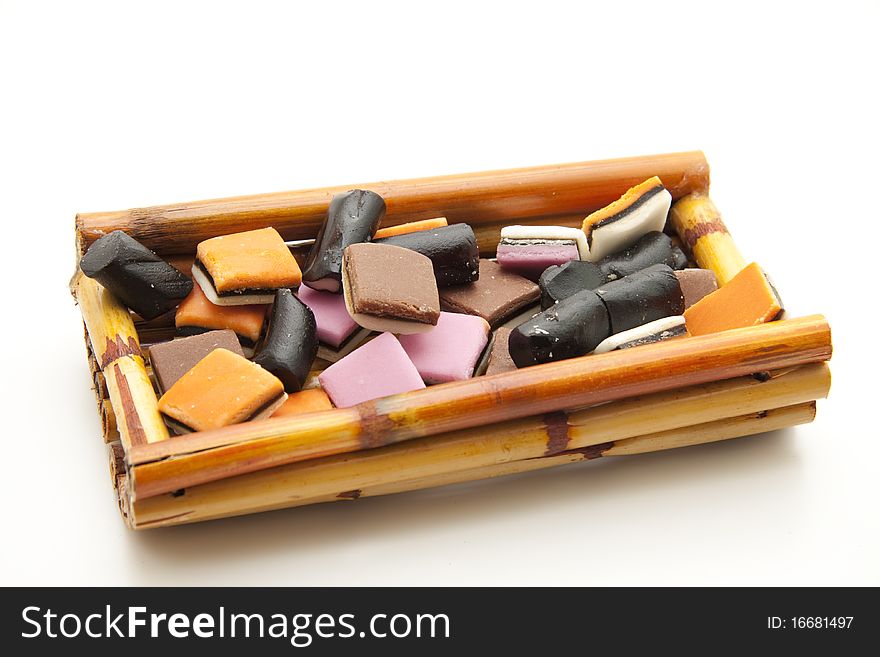 Colored licorice in receptacles from bamboo