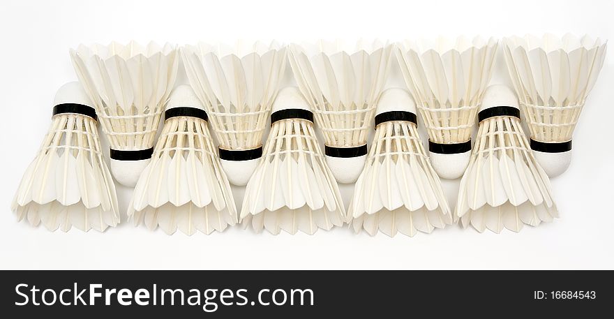 Row of badminton shuttlecocks on white background. Row of badminton shuttlecocks on white background