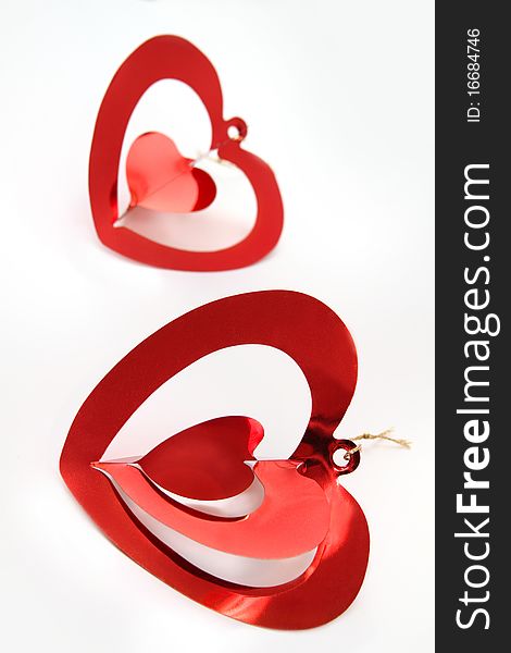 Two red shiny  hearts on white background
