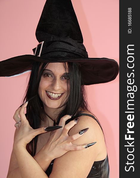 Brunette with a black dress and witch hat for halloween