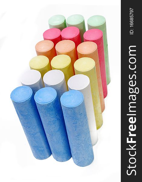 Multicolored chalk sticks on white background