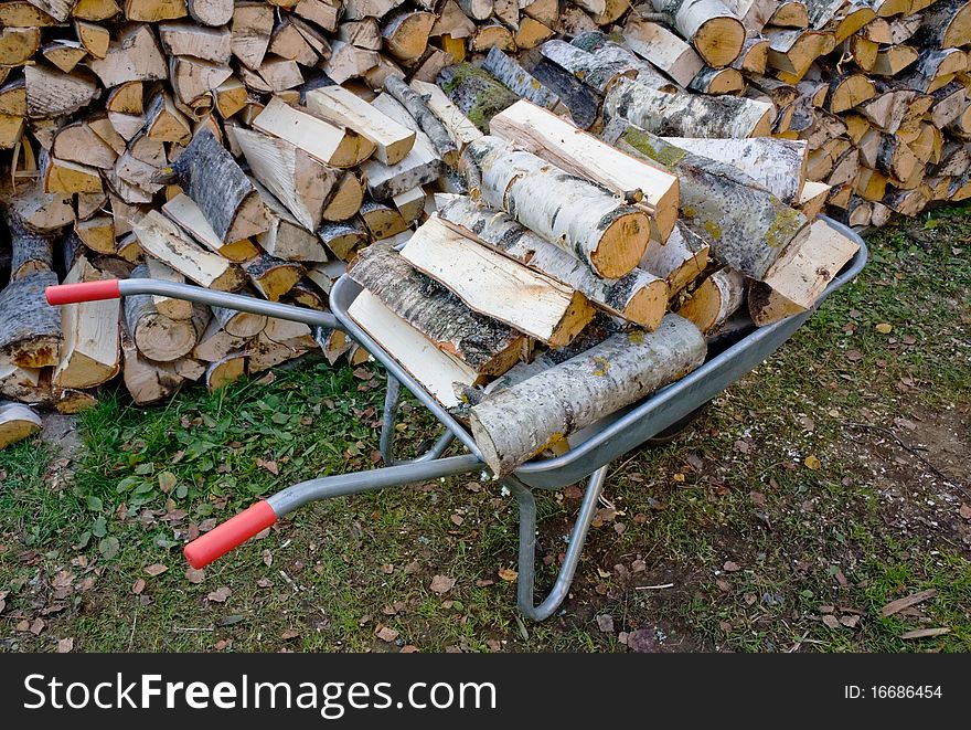 Garden Wheelbarrow with Chopped birch fire wood. Garden Wheelbarrow with Chopped birch fire wood