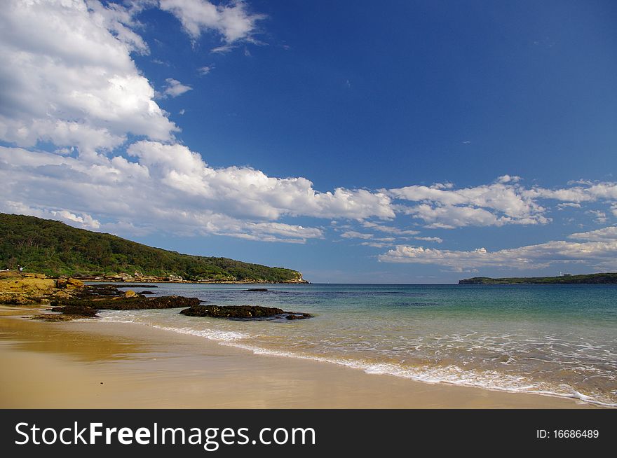 Congwong bay beach in La Perouse, Sydney, with lovely blue sky and white clouds. Congwong bay beach in La Perouse, Sydney, with lovely blue sky and white clouds.