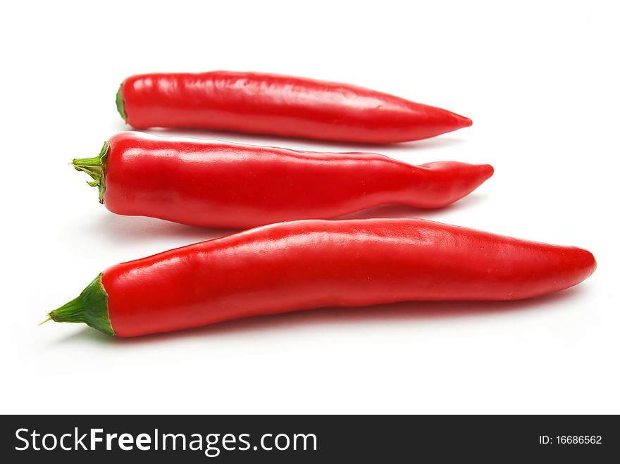 Three chili peppers over white. Three chili peppers over white