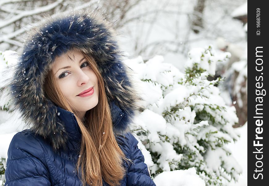 Smiling young woman in blue coat outdoors. Smiling young woman in blue coat outdoors