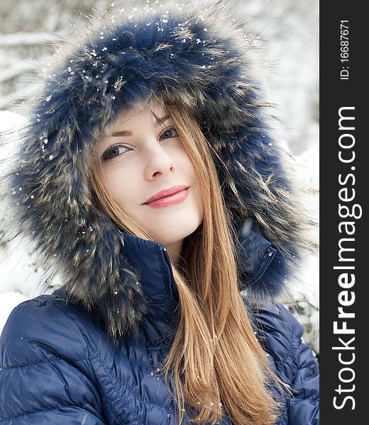 Smiling young woman in blue coat outdoors. Smiling young woman in blue coat outdoors