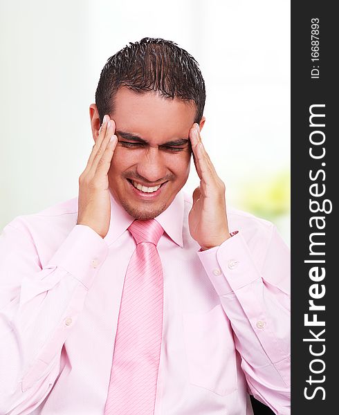 Young businessman with headache, expressing pain with his face