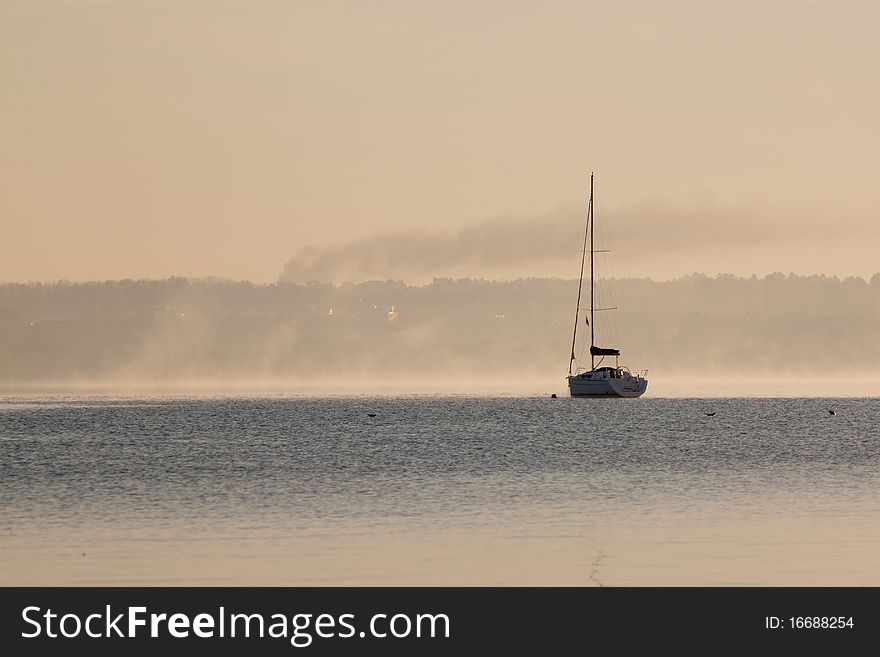 Sunrise over lake with boat. Sunrise over lake with boat