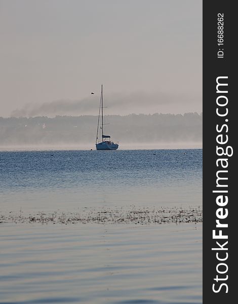 Sunrise over lake with boat. Sunrise over lake with boat