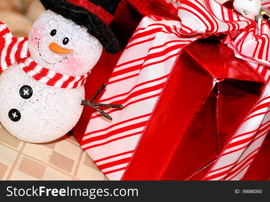 Snowman decoration with red wrapped gift. Snowman decoration with red wrapped gift