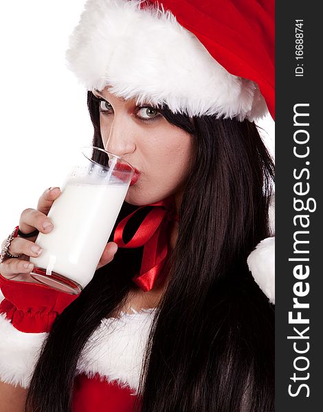 A woman dressed in a santa out fit drinking milk. A woman dressed in a santa out fit drinking milk.