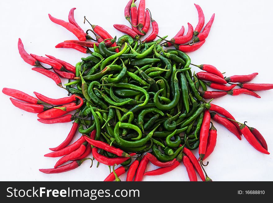 Sun shape made of gren and red chili peppers. Sun shape made of gren and red chili peppers
