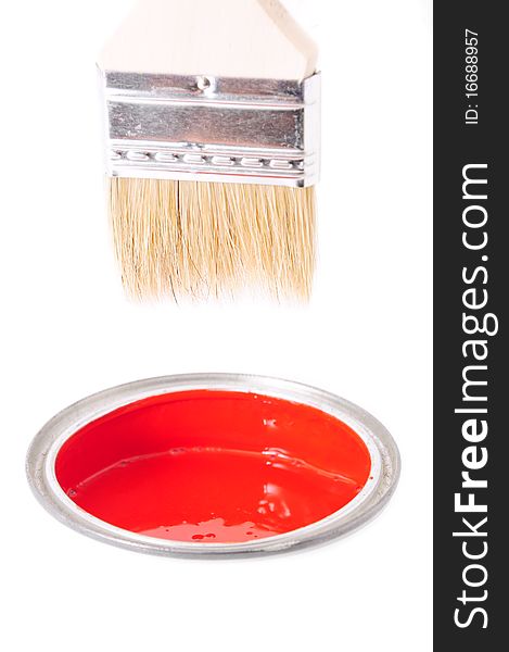 The red color in a bucket and paint brush
