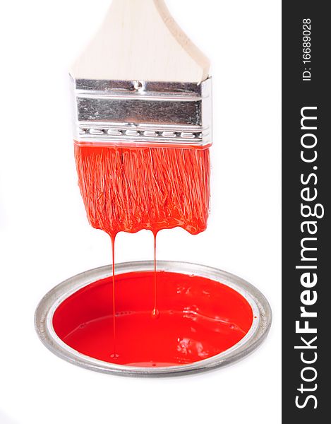 The red color in a bucket and paint brush