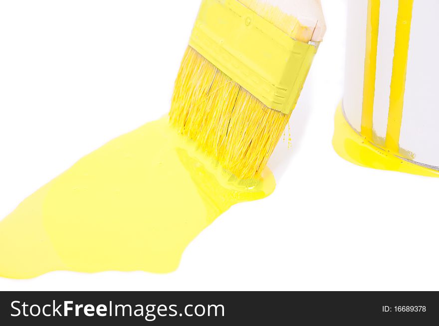 Brush with yellow paint thrown a bucket. Brush with yellow paint thrown a bucket
