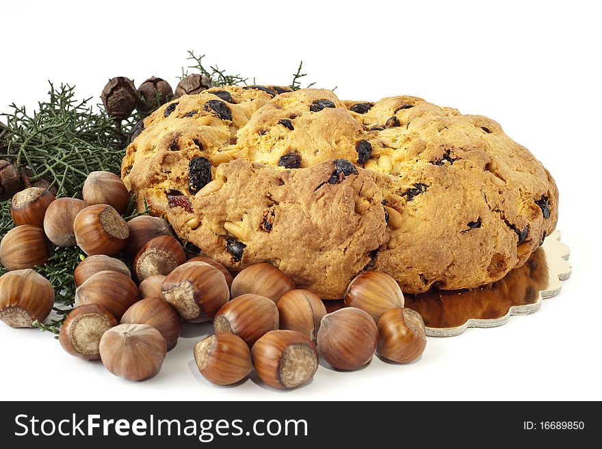 Typical Italian Christmas cake and nuts on white background. Typical Italian Christmas cake and nuts on white background