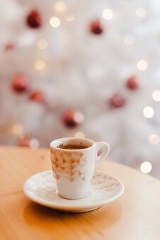 Cup Of Espresso Or Short Coffee In White Cup In Cosy Christmas Arrangement, Festive Decoration With White Bokeh Background, Copy Stock Image
