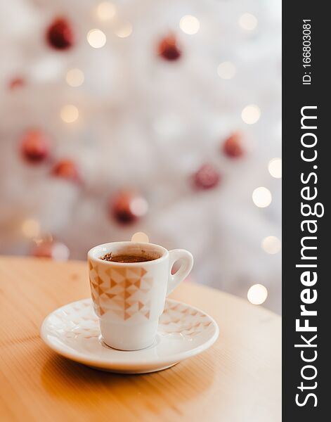 Cup Of Espresso Or Short Coffee In White Cup In Cosy Christmas Arrangement, Festive Decoration With White Bokeh Background, Copy