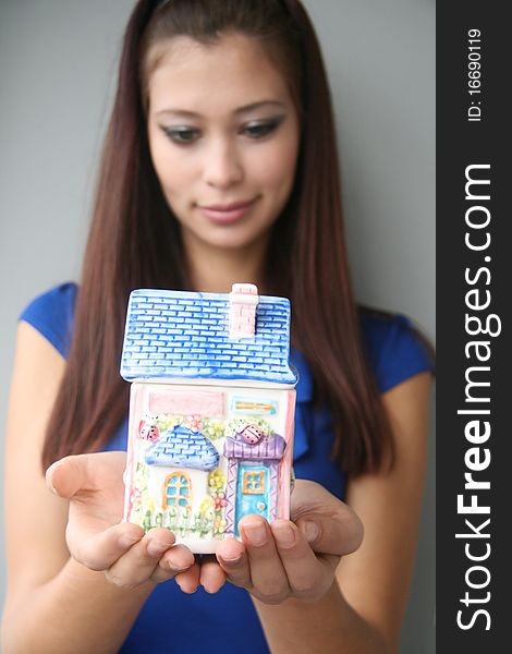 Girl holds a little house in her hands. Girl holds a little house in her hands