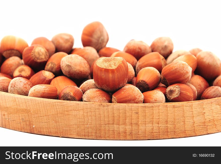 Hazelnuts on a wooden plate. Hazelnuts on a wooden plate