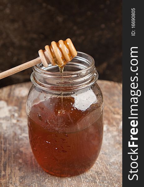 Glass pot with the fresh floeing honey. Glass pot with the fresh floeing honey