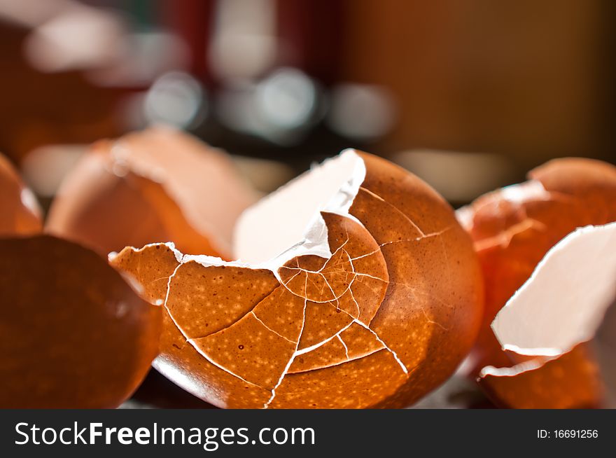 Cracked eggshells with backlight from sun through a window, cracked into interesting patterns.