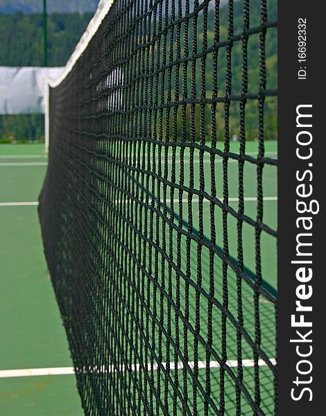 Yellow-red balls on a green tennis court. Yellow-red balls on a green tennis court